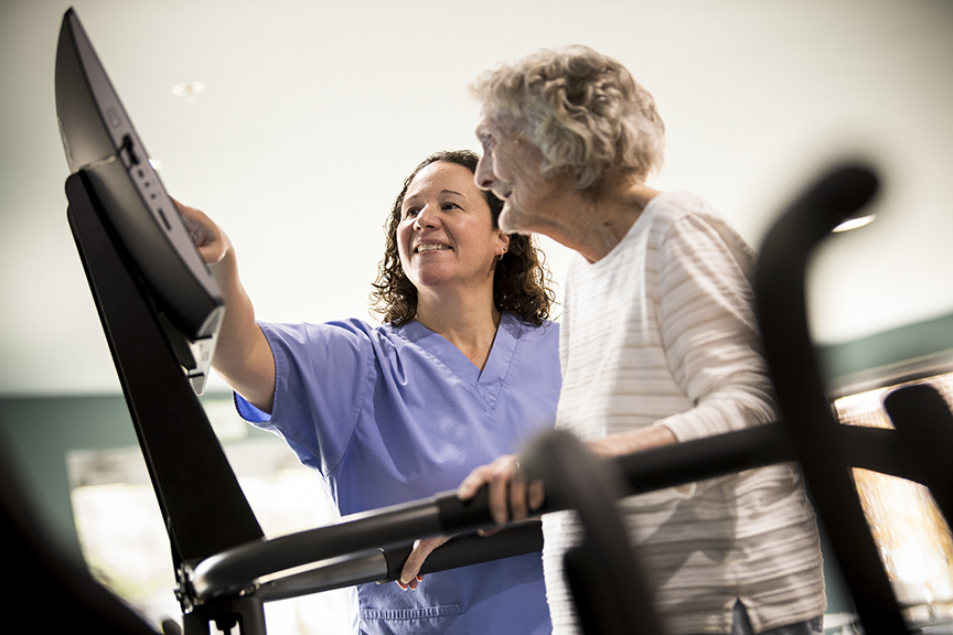 Therapist with woman on balance machine