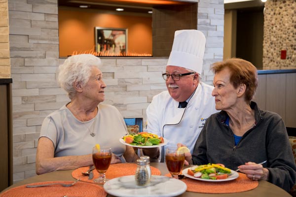 Chef with women eating