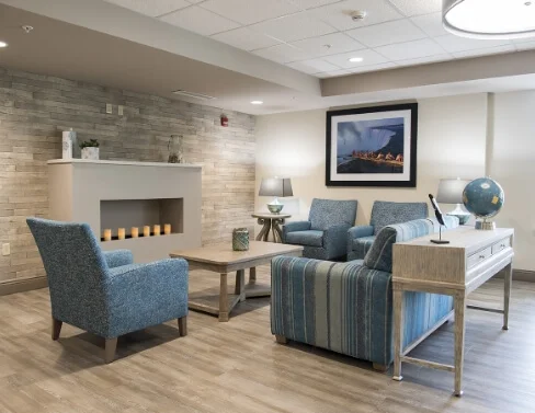 Lounge with fireplace, armchairs and sofa