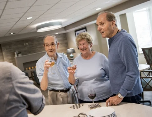 Senior residents chatting and enjoying drinks at a social gathering