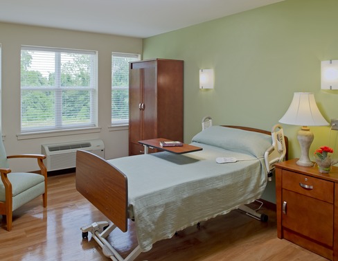 Patient room with bed, nightstand and wardrobe at Lorien Bulle Rock
