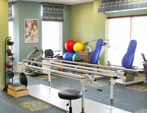 Rehabilitation gym with parallel bars and exercise equipment at Lorien Bulle Rock