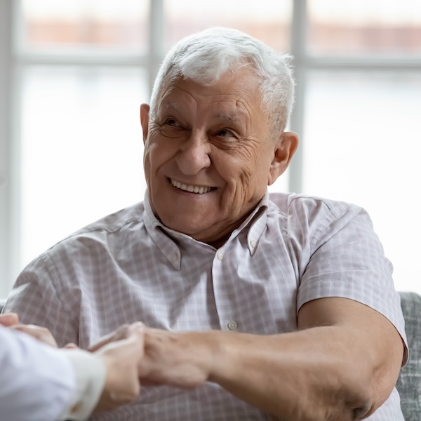 Smiling senior man seated in a chair