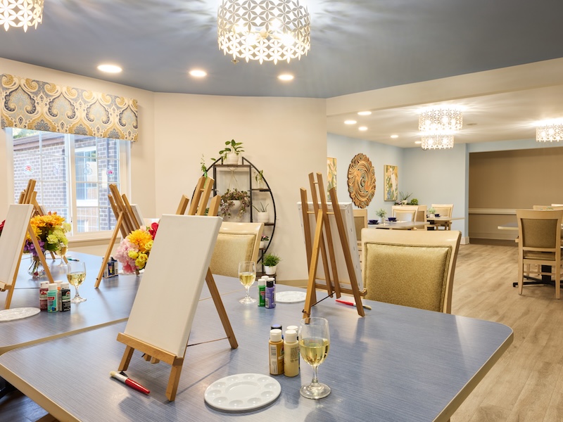 Art studio with easels and canvases set up for painting at Lorien Harmony Park