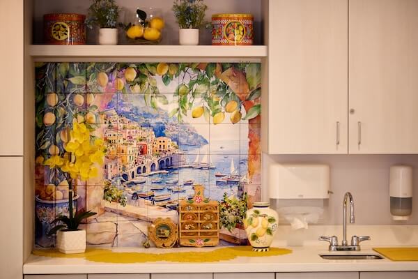 Kitchenette with colorful tiled coastal mural backsplash at Lorien Harmony Park