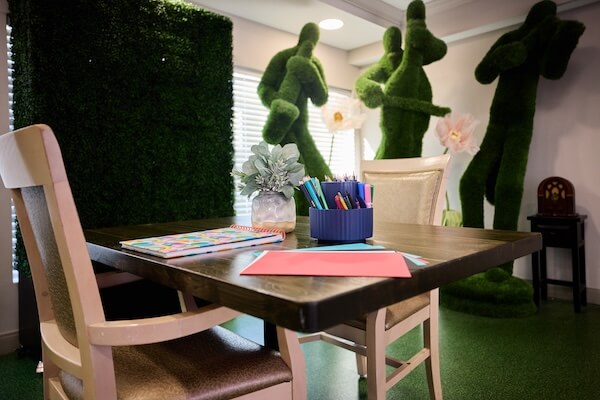 Activity room with topiary garden sculptures and craft table at Lorien Harmony Park