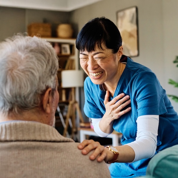 Smiling caregiver talking with a senior man