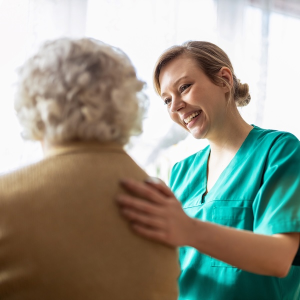 Health visitor talking to a senior woman