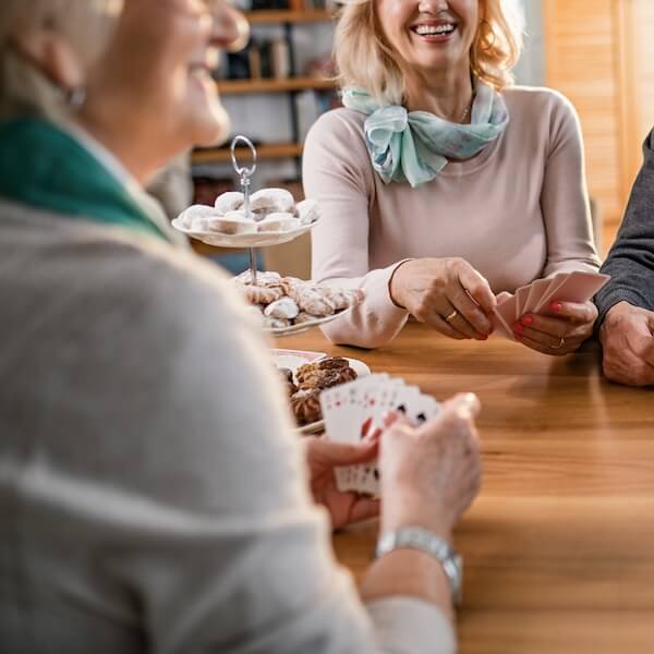 Seniors playing cards together at a table